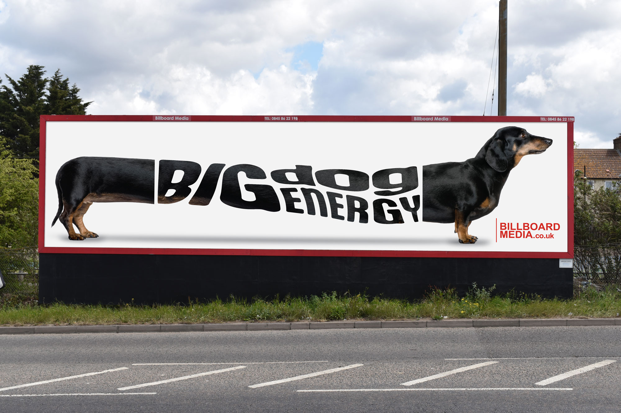 BigDogEnergy 96 Sheet Photo of a 96 sheet billboard in London. The image displays a very long sausage dog that has 'Big God Energy' in the middle. Purpose of the image is to convey the striking ntsure of 96 sheet billboards and highlight their huge size.